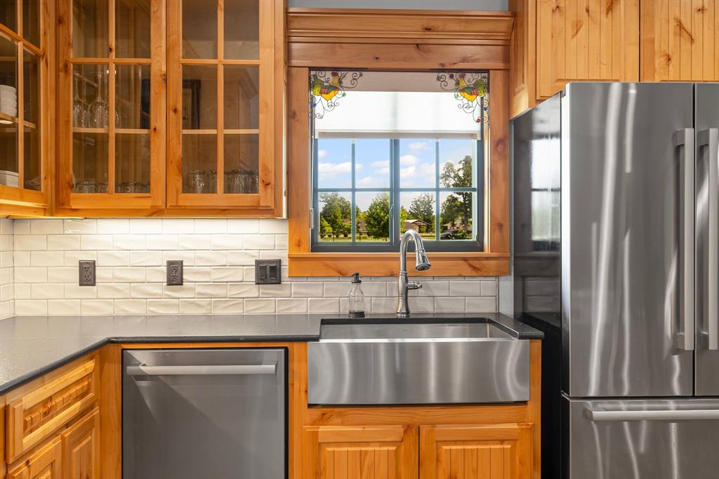 2072 East US 69 Emory, TX 75440 - Photo 16 of 39 a kitchen with stainless steel appliances granite countertop a refrigerator and a sink