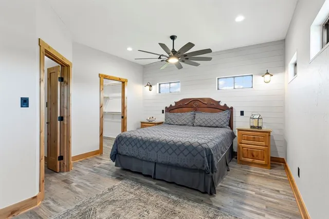 a spacious bedroom with a bed and a chandelier
