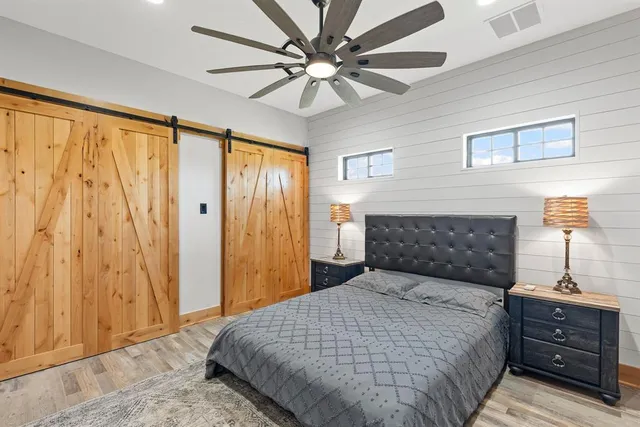 a bedroom with a bed and a chandelier