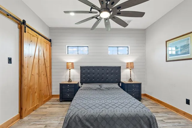 a bedroom with a bed and a chandelier