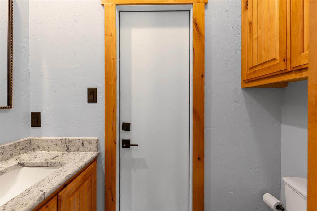 2072 East US 69 Emory, TX 75440 - Photo 29 of 39 a bathroom with a granite countertop sink and a mirror