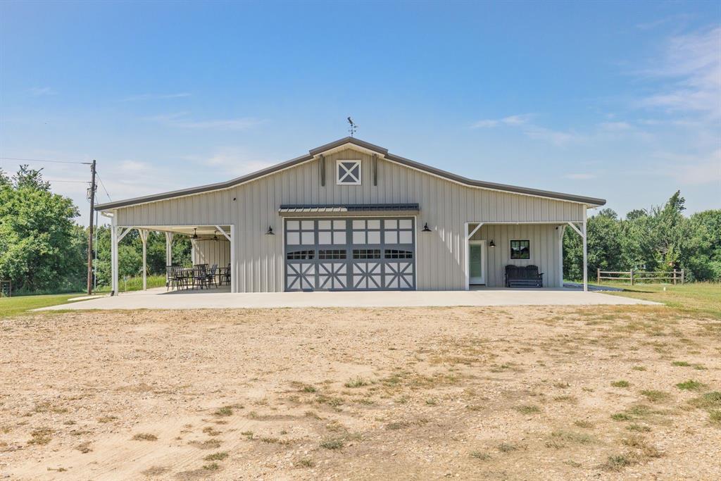 2072 East US 69 Emory, TX 75440 - Photo 31 of 39 a front view of a house with a yard and garage