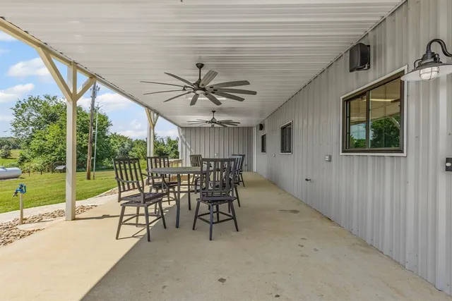 a view of a porch with furniture and a backyard