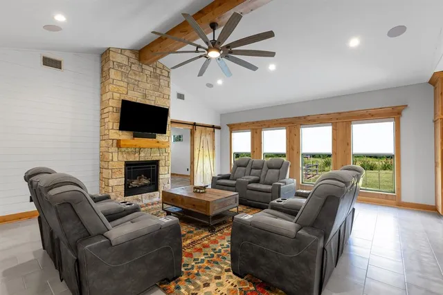a living room with furniture a fireplace and a flat screen tv