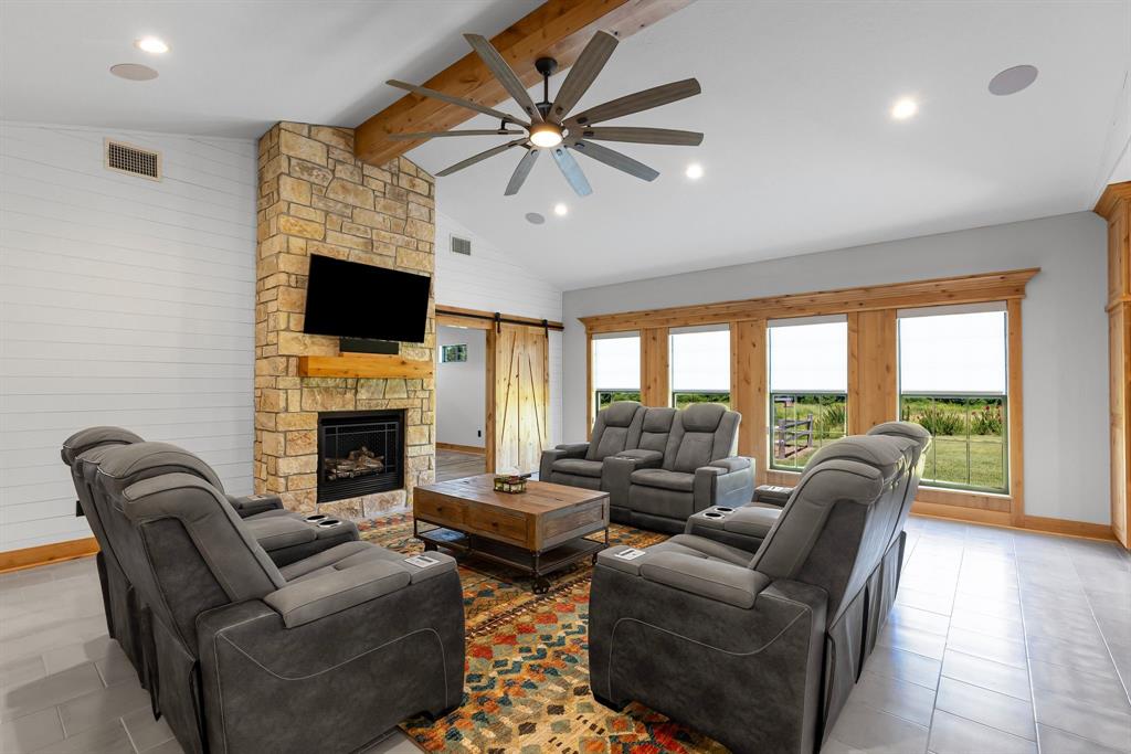 2072 East US 69 Emory, TX 75440 - Photo 7 of 39 a living room with furniture a fireplace and a flat screen tv