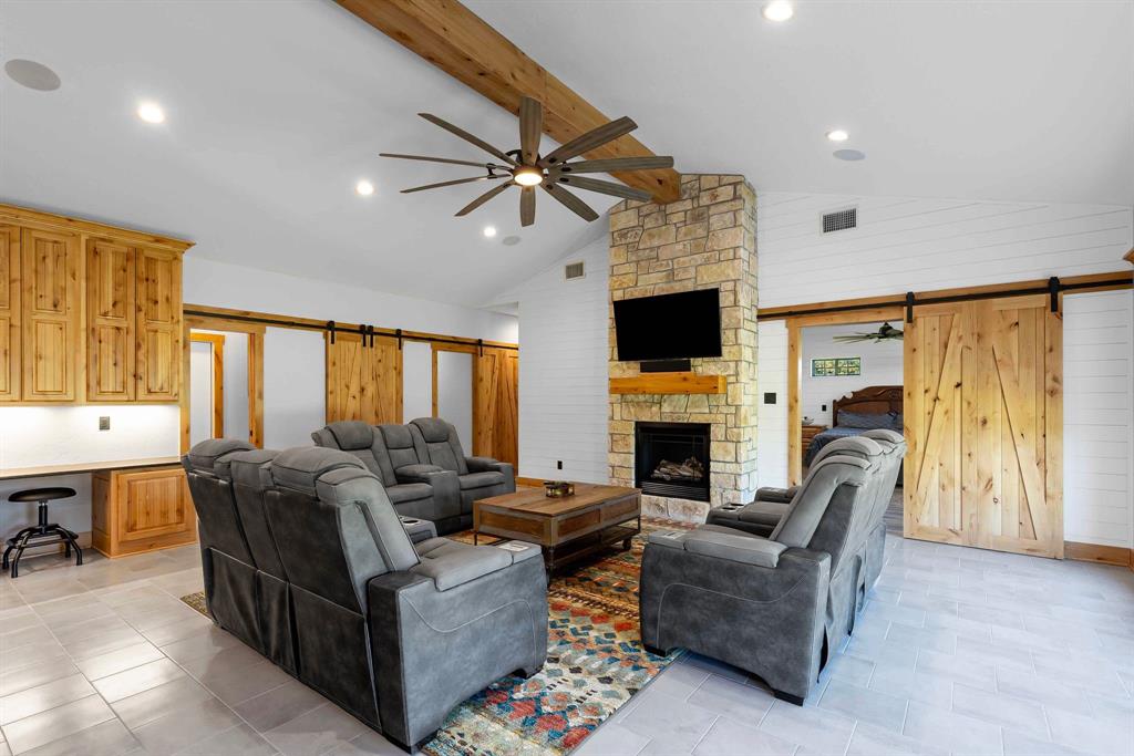 2072 East US 69 Emory, TX 75440 - Photo 8 of 39 a living room with furniture a fireplace and a flat screen tv