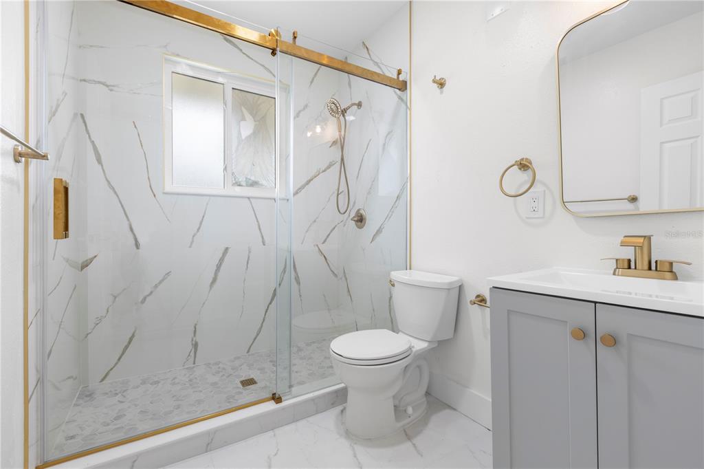 14060 Miramar Avenue, Unit 1 #2 #3 #4 Madeira Beach, FL 33708 - Photo 14 of 38 a bathroom with a shower a toilet and a sink