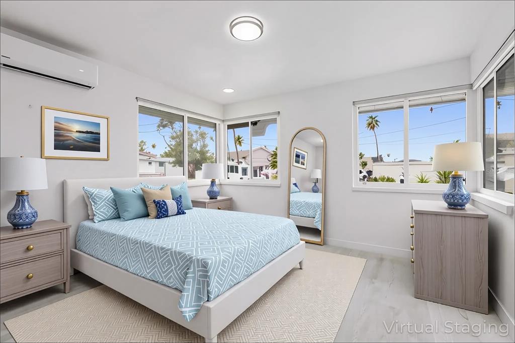 14060 Miramar Avenue, Unit 1 #2 #3 #4 Madeira Beach, FL 33708 - Photo 15 of 38 a bedroom with a large bed and a dresser