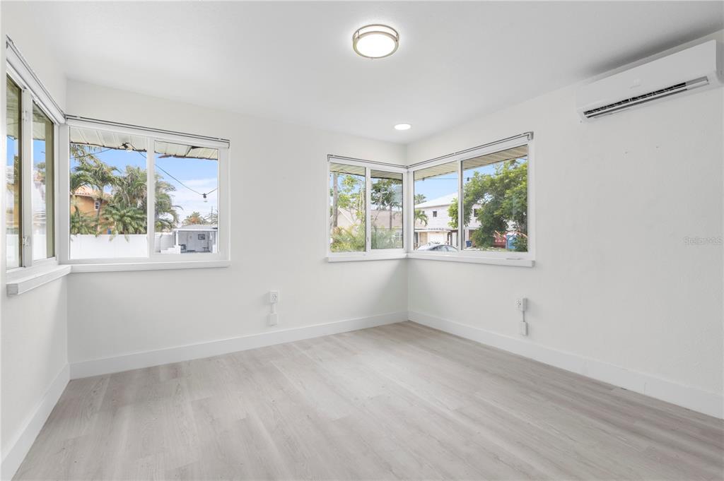 14060 Miramar Avenue, Unit 1 #2 #3 #4 Madeira Beach, FL 33708 - Photo 20 of 38 wooden floor in an empty room with a window