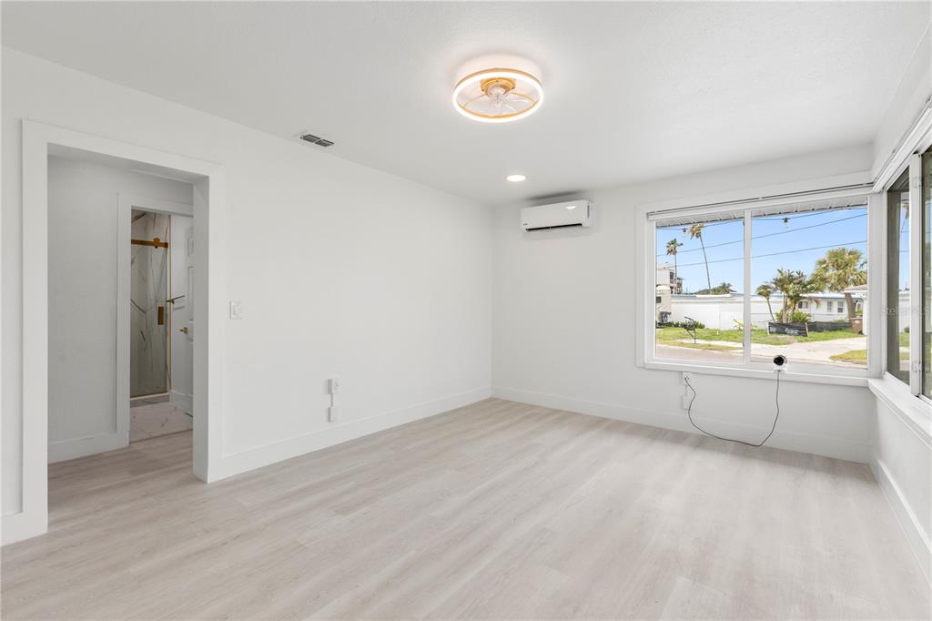 14060 Miramar Avenue, Unit 1 #2 #3 #4 Madeira Beach, FL 33708 - Photo 23 of 38 wooden floor in an empty room with a window