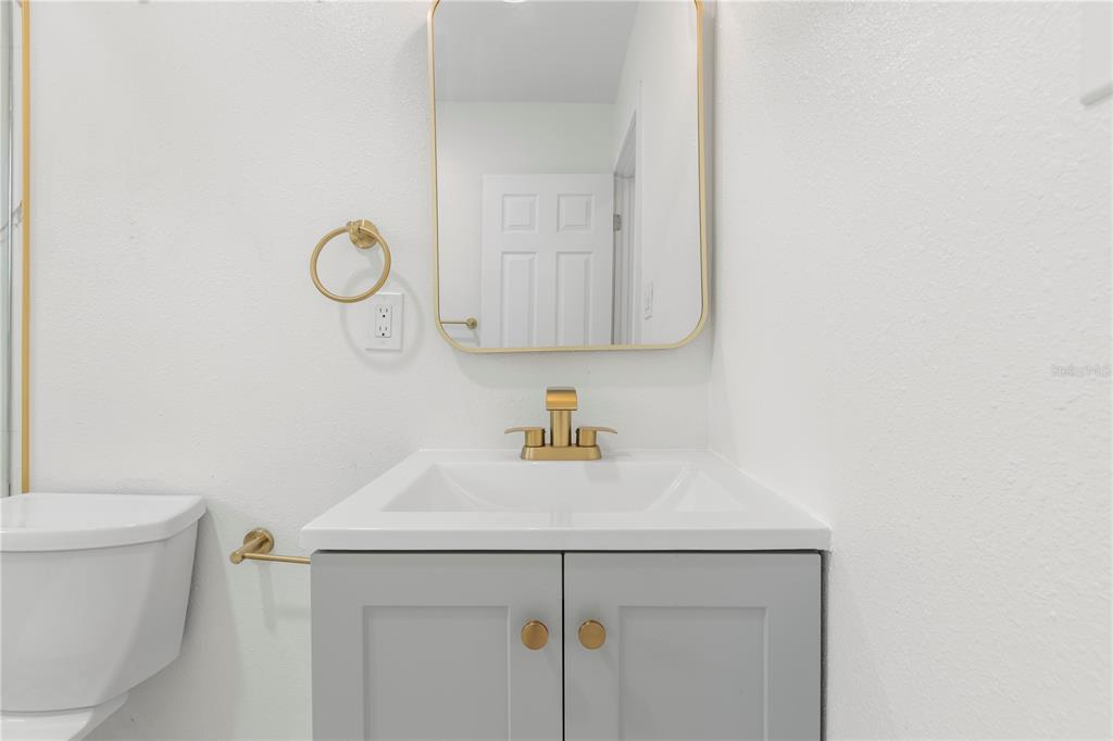 14060 Miramar Avenue, Unit 1 #2 #3 #4 Madeira Beach, FL 33708 - Photo 25 of 38 a bathroom with a sink a toilet and vanity