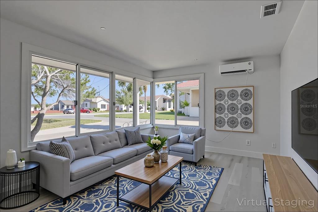 14060 Miramar Avenue, Unit 1 #2 #3 #4 Madeira Beach, FL 33708 - Photo 8 of 38 a living room with furniture and a flat screen tv