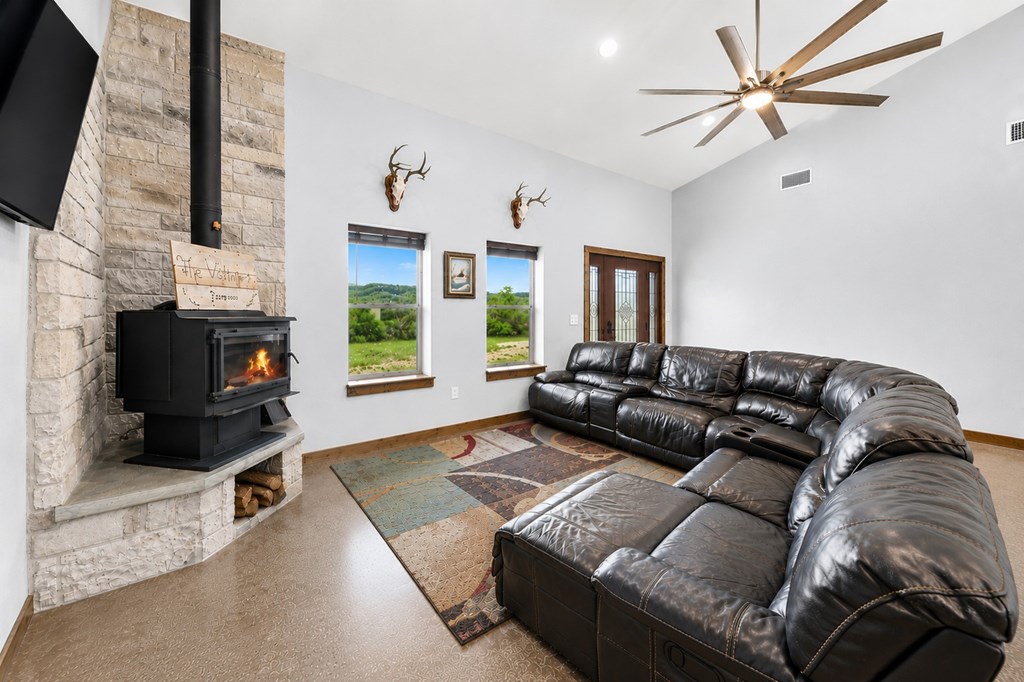161 Balsly Road East Center Point, TX 78010 - Photo 8 of 28 a living room with furniture a flat screen tv and a fireplace