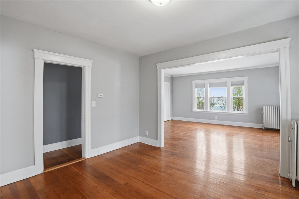 3 Boyden St Extension Webster, MA 01570 - Photo 11 of 34 a view of an empty room with wooden floor and a window
