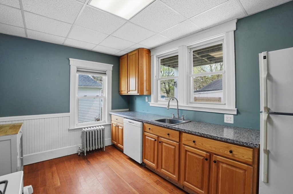 3 Boyden St Extension Webster, MA 01570 - Photo 15 of 34 a kitchen with granite countertop a sink a window and a counter top space