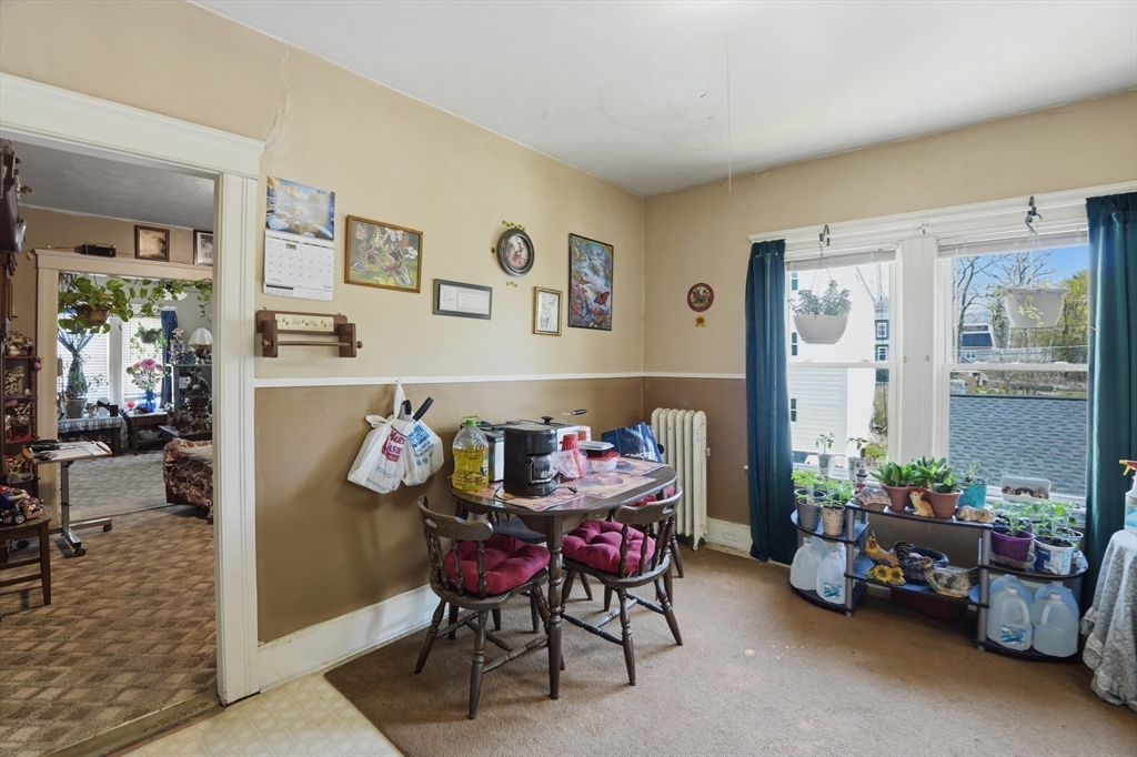 3 Boyden St Extension Webster, MA 01570 - Photo 25 of 34 a dining room with furniture and a potted plant