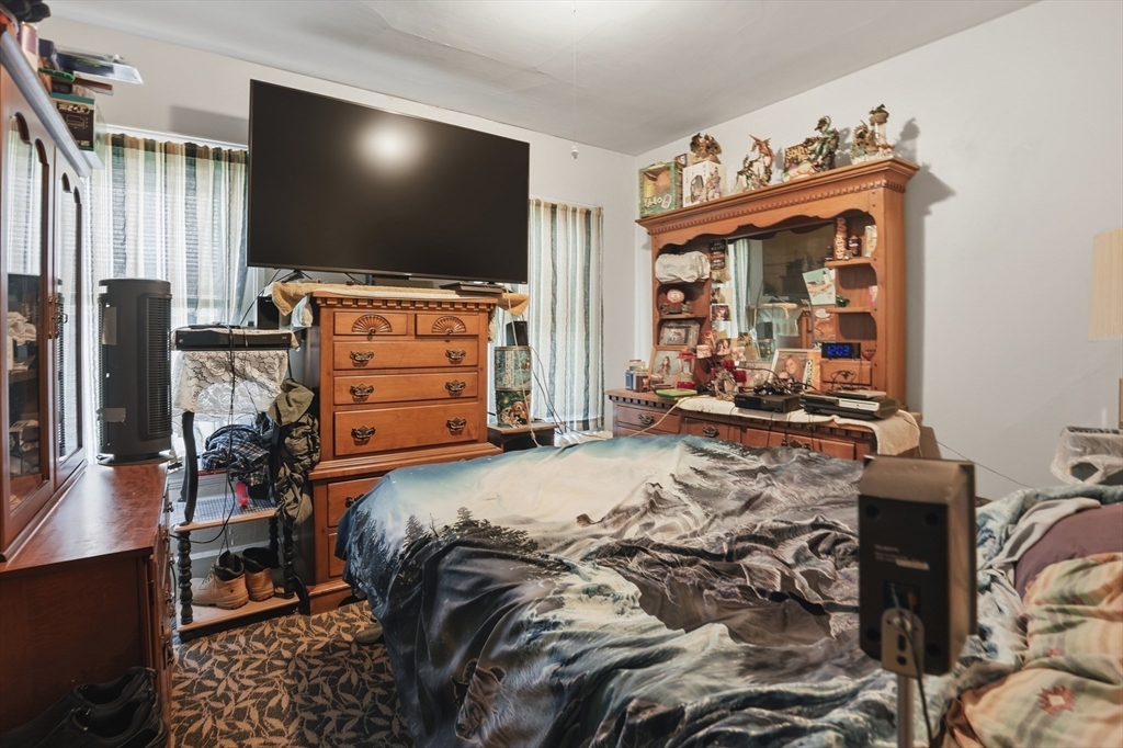 3 Boyden St Extension Webster, MA 01570 - Photo 31 of 34 a bedroom with a bed and a flat screen tv