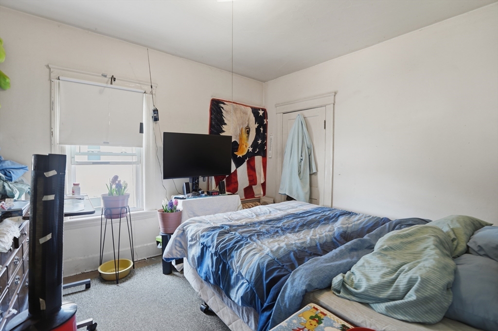 3 Boyden St Extension Webster, MA 01570 - Photo 32 of 34 a bedroom with a bed and a flat screen tv