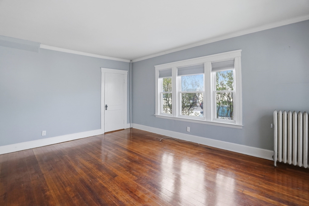 3 Boyden St Extension Webster, MA 01570 - Photo 6 of 34 a view of an empty room with wooden floor and a window