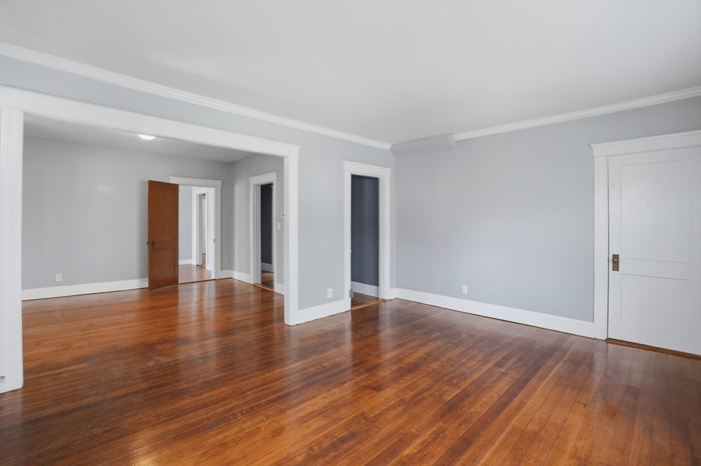 3 Boyden St Extension Webster, MA 01570 - Photo 8 of 34 a view of an empty room with wooden floor and a window