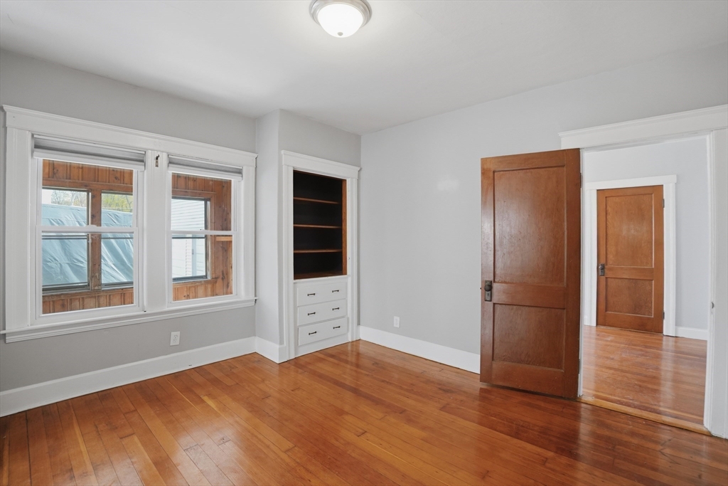 3 Boyden St Extension Webster, MA 01570 - Photo 10 of 34 a view of empty room with wooden floor and fan