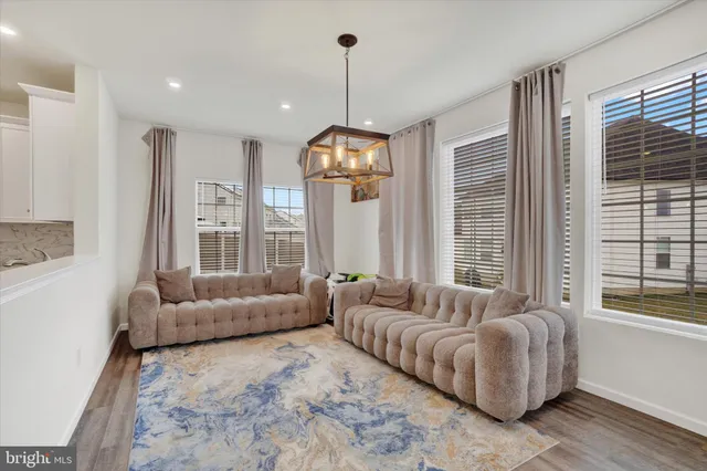 a living room with furniture and a chandelier