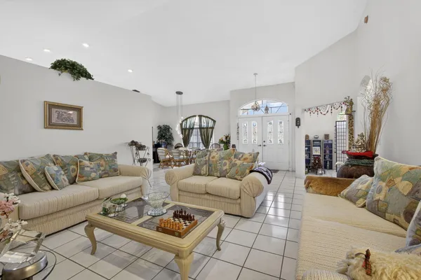 a living room with lots of furniture and kitchen view