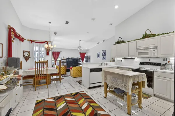 a kitchen with a sink a stove and cabinets