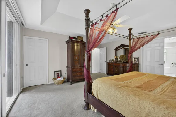 a bedroom with a bed and a chandelier
