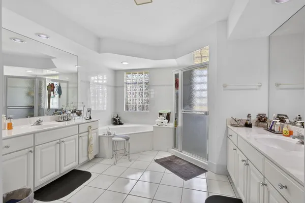 a bathroom with a sink a toilet a mirror and a tub