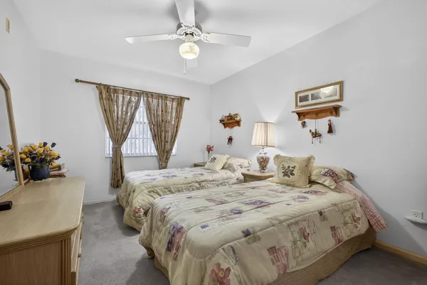a view of backyard with large trees and wooden fence