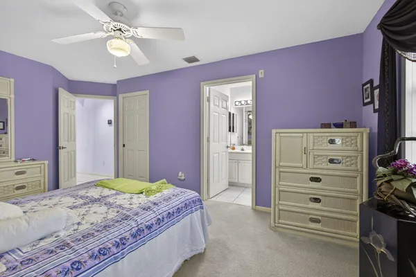 a backyard of a house with table and chairs under an umbrella