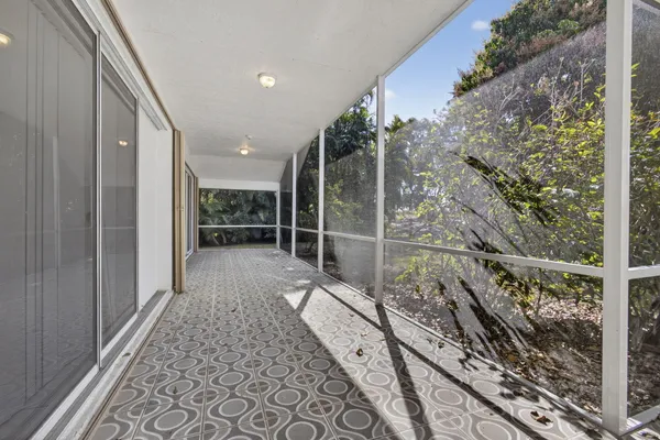 an aerial view of residential houses with outdoor space and pool