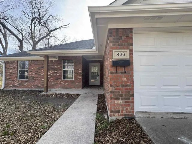 a view of a brick house with a large door