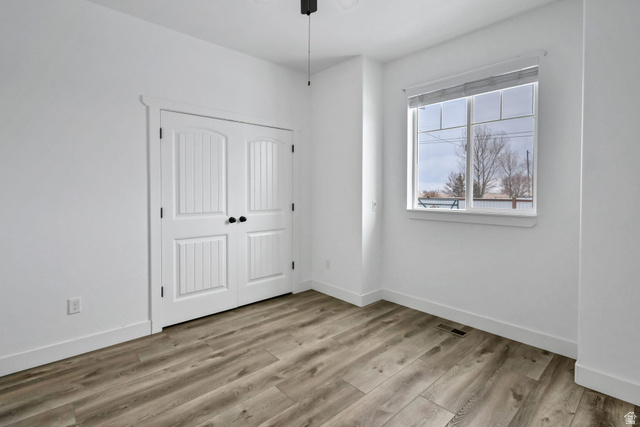 1103 North Brooklyn Road Monroe, UT 84754 - Photo 17 of 78 Unfurnished bedroom featuring light wood finished floors, a closet, and ceiling fan