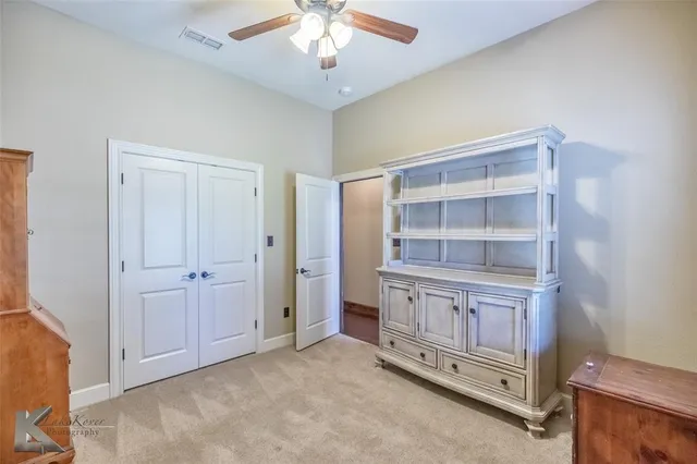 a view of an empty room with a cabinet