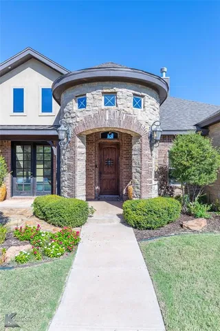 a front view of a house with a garden