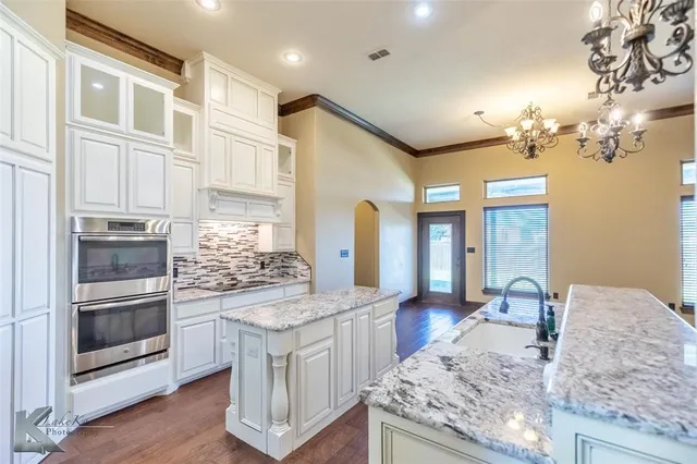 a kitchen with stainless steel appliances granite countertop a stove and a sink