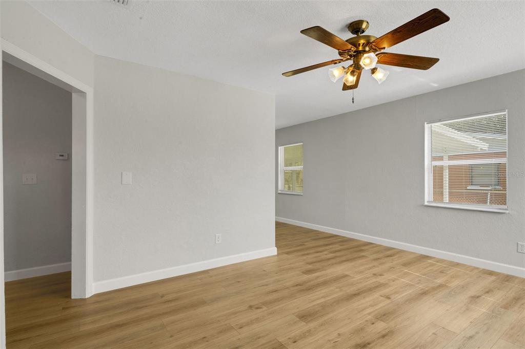 2716 Hardin Combee Road Lakeland, FL 33801 - Photo 11 of 32 an empty room with wooden floor and windows