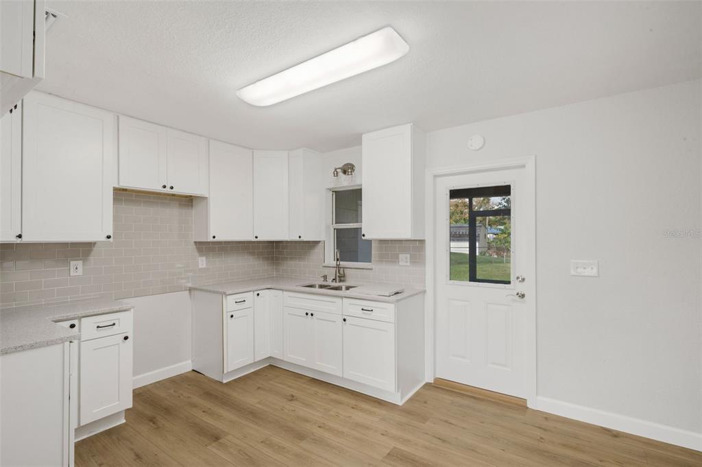 2716 Hardin Combee Road Lakeland, FL 33801 - Photo 12 of 32 a kitchen with a sink cabinets and wooden floor