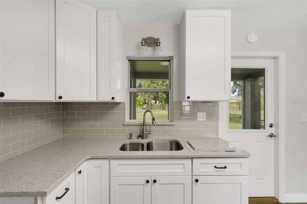 2716 Hardin Combee Road Lakeland, FL 33801 - Photo 14 of 32 a kitchen with a sink cabinets and window