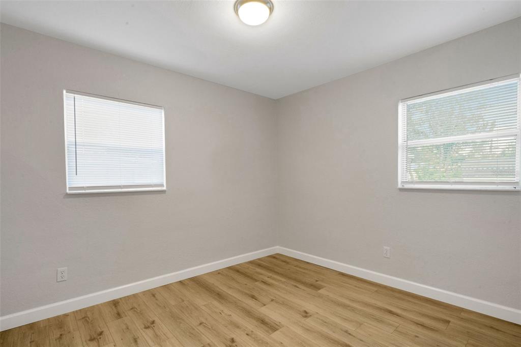 2716 Hardin Combee Road Lakeland, FL 33801 - Photo 15 of 32 a view of an empty room with wooden floor and a window