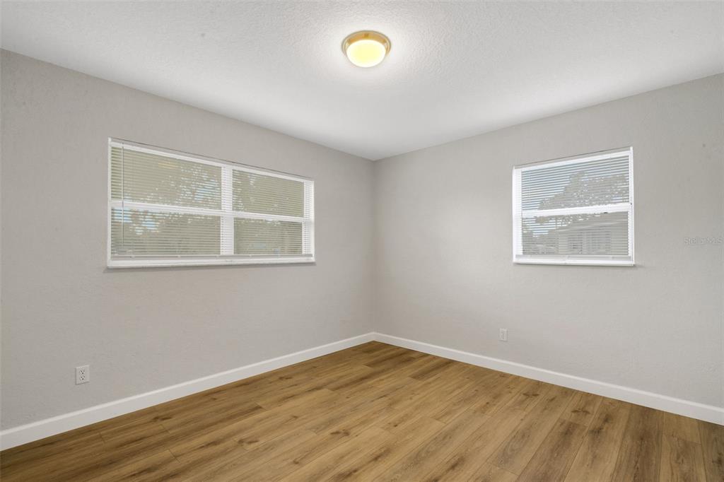 2716 Hardin Combee Road Lakeland, FL 33801 - Photo 17 of 32 a view of empty room with wooden floor and fan