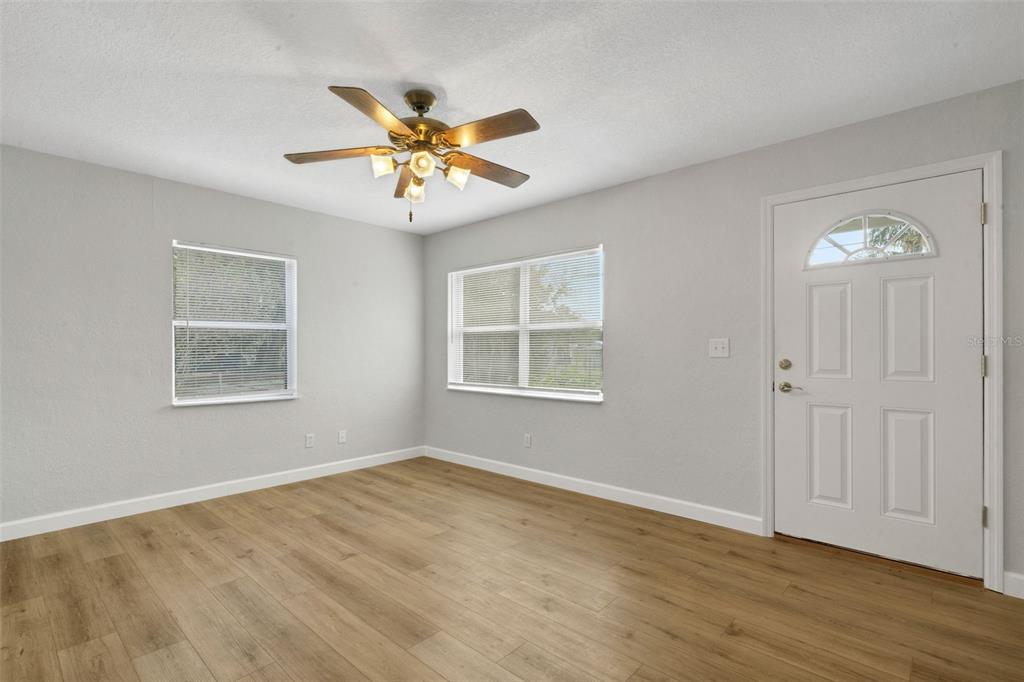2716 Hardin Combee Road Lakeland, FL 33801 - Photo 19 of 32 a view of an empty room with a window and wooden floor