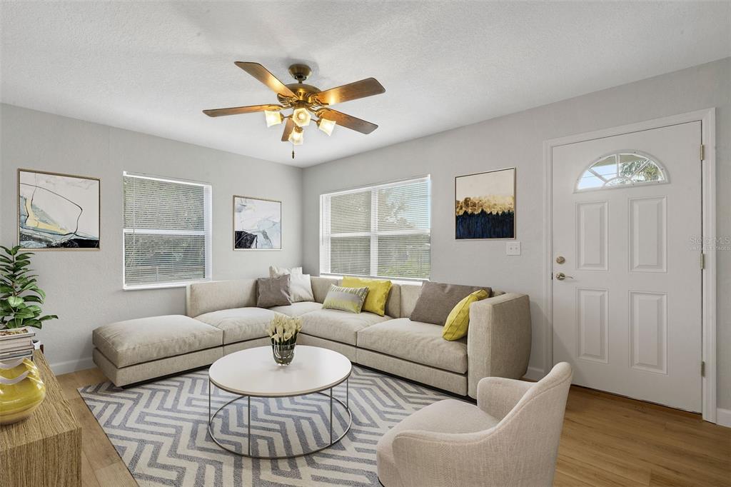 2716 Hardin Combee Road Lakeland, FL 33801 - Photo 2 of 32 a living room with furniture a window and a wooden floor
