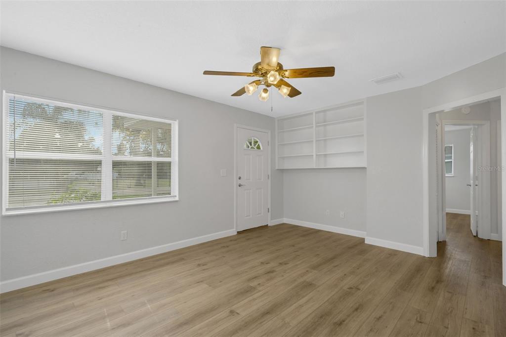 2716 Hardin Combee Road Lakeland, FL 33801 - Photo 9 of 32 wooden floor in an empty room with a window