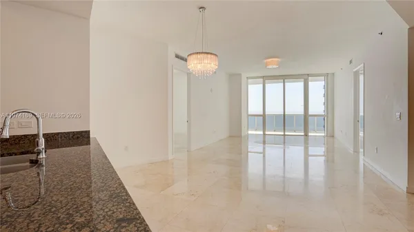a kitchen with stainless steel appliances granite countertop a sink and a refrigerator