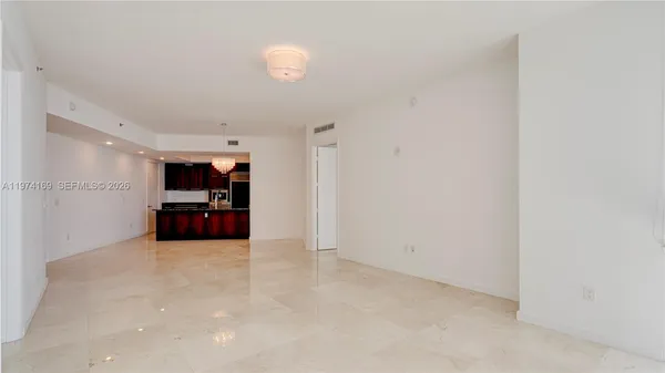an empty room with closet and a window