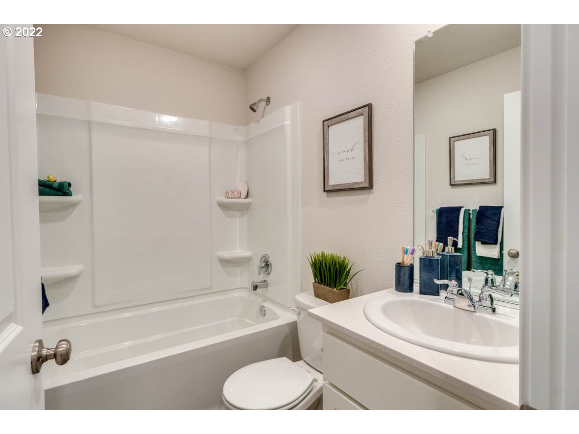 2817 North 2nd Way Ridgefield, WA 98642 - Photo 29 of 31 a bathroom with a granite countertop sink a toilet a tub and shower