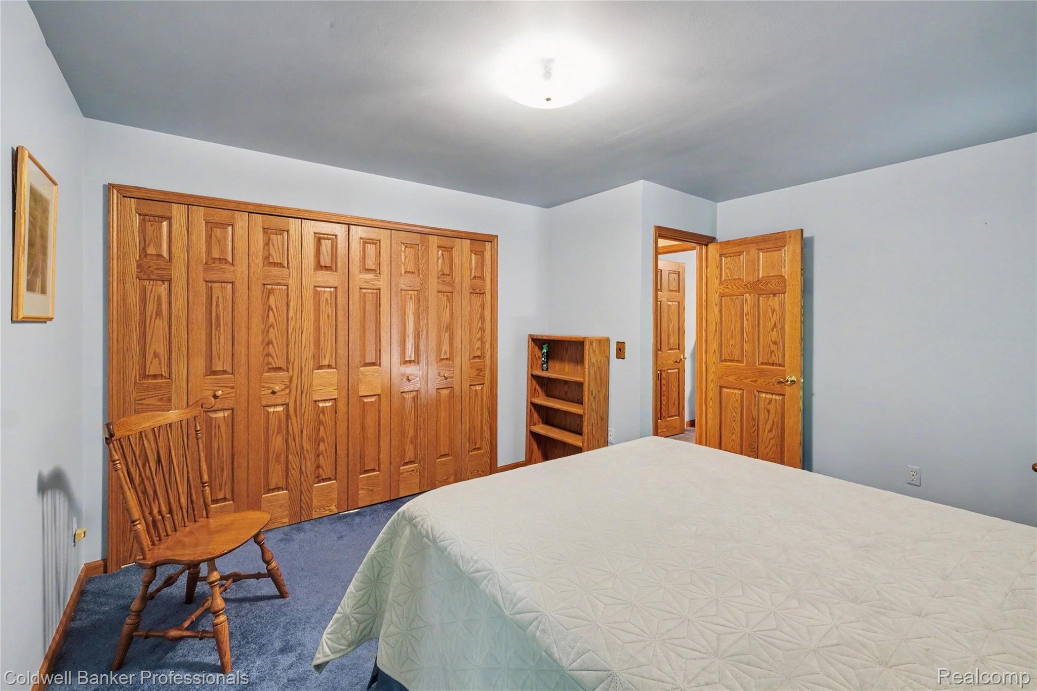 3583 Mitchell Road Metamora, MI 48455 - Photo 38 of 58 Bedroom featuring extensive bi-fold closet doors, wall-to-wall carpeting, wood-finish trim, a wood-finish door, and recessed lighting